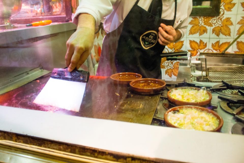 Madrid: Tapas & Wine Tasting Tour with Local Guide - Walking logistics that matter: small group, short transfers, stand-and-eat style