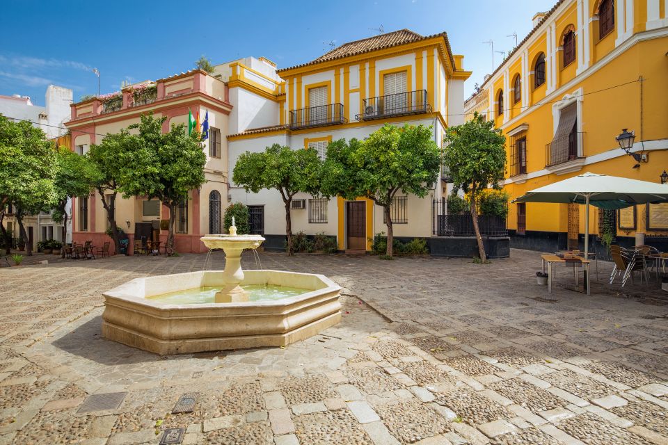 Seville: Relaxing City Bike Tour with a Tour Guide - Barrio Santa Cruz: Cobblestones, Stories, and an Easy Way In